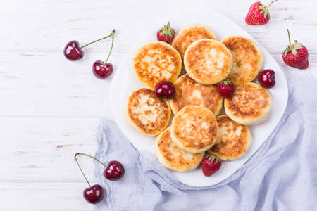 Homemade cottage cheese pancakes with strawberry and cherryの写真素材