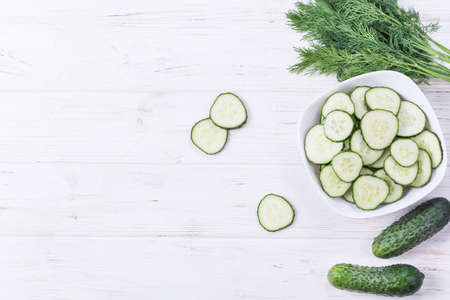 Cucumber cut in bowl as ingredient for saladの写真素材