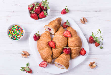 Delicious breakfast with fresh croissants and strawberryの写真素材