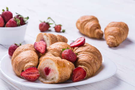 Delicious breakfast with fresh croissants and strawberryの写真素材