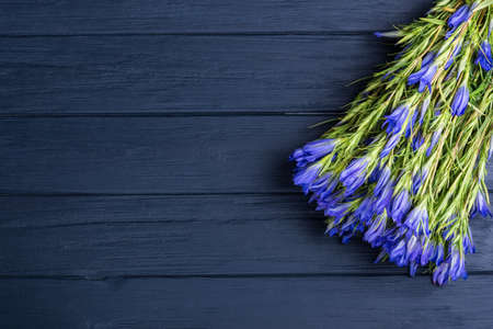 Bouquet of blue flowers on blue wooden backgroundの写真素材