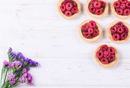 Sweet tartlet with raspberries on white backgroundの写真素材