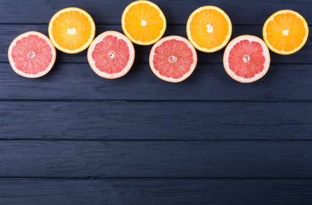 Orange and grapefruit slices on wooden background