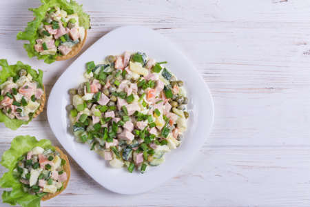 Traditional russian salad Olivier in tartlet with lettuce leavesの写真素材