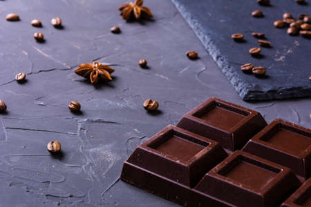 Broken chocolate bar slice on grey backgroundの写真素材
