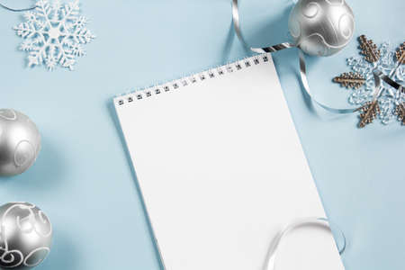 Christmas layout on a blue background. Flatley. Phone, laptop, charging wire. Close-up. Place for an inscription.の写真素材