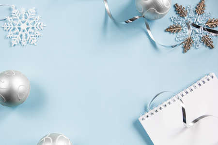Christmas layout. On a blue background. Phone, notebook, Christmas balls. Flatley. Place for an inscription.の写真素材