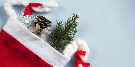 Christmas layout on a blue background. Flatley. Santa Claus hat. Close-up. Place for an inscription....
