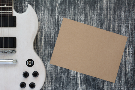 white guitar on grey old wooden tableの写真素材