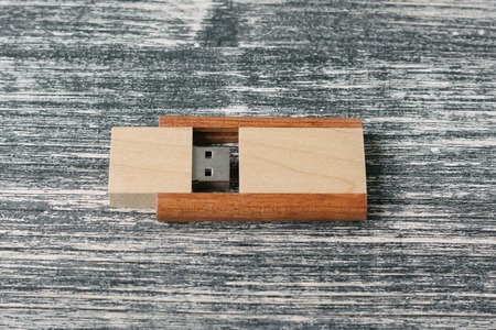 Creative wooden usb stick on dark background. Wooden USB flash drive on white and black tableの写真素材