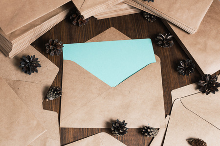 Retro kraft envelops, Pine cones on old wooden table, deskの写真素材