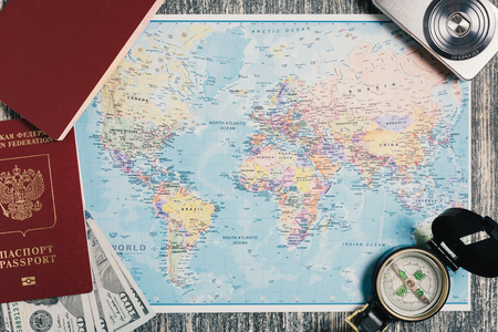 Russian passport with dollars on world map. Preparing for travelの写真素材