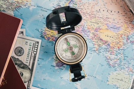 Russian passport with dollars on world map. Preparing for travelの写真素材