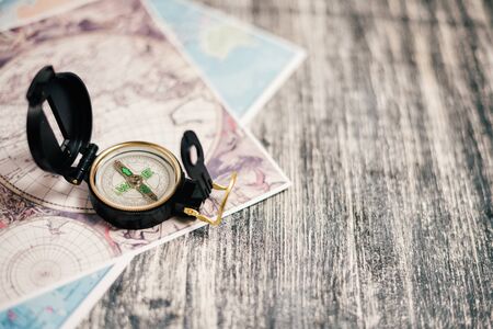 Compass with old map on a wooden black and white backgroundの写真素材