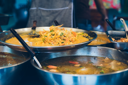 Street food in a wok and pan. Many kind of Thai food at evening marketの写真素材