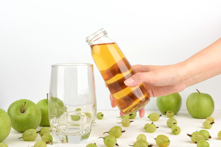 Golden Apple juice in a glass. Detox green Apple and gooseberry juice in a glass, healthy drinks conceptの写真素材