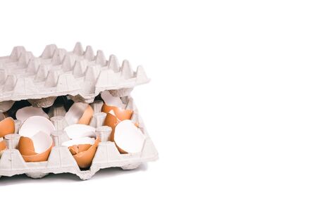 Egg shells in egg box. Close-up view of raw chicken eggs isolated on white background