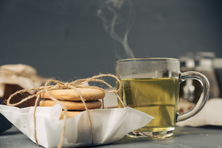Homemade sugar cookies with honey. Ginger breads with bakery paper tied with a rope on white...