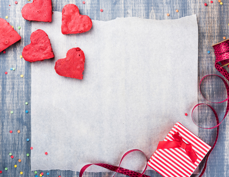 Valentine's Day Background, paper on wooden table. Red velvet heart cookies, Gift box, ribbonの写真素材