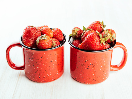 Fresh sweet berries in a red cup.の写真素材
