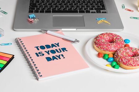 Work table with green plant in grey pot, notebook with an inscription Today is your day! Laptop and doughnuts in home office studio. Freelance designer or blogger desktop. Wall Background, copy space for your textの写真素材