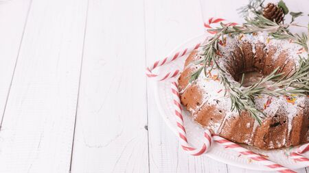 Traditional Christmas fruit cake on a white wooden tableの写真素材