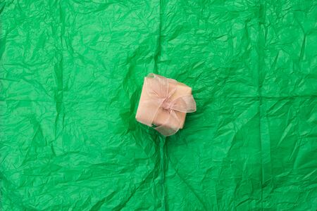 A gift boxes on a green packing crumpled the paper. Flat lay, top viewの写真素材