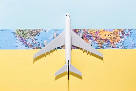 Model airplane on opens a world map.