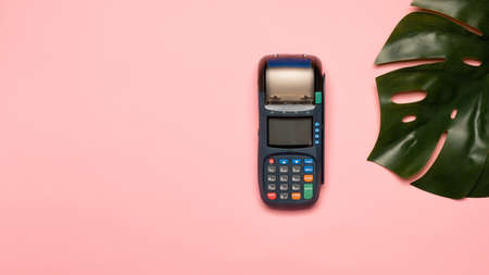 NFC payment contactless terminal on a pink background