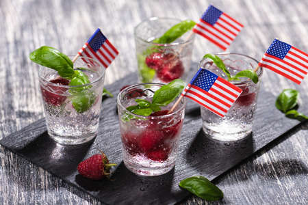 Alcohol shots of berries cocktail with a raspberryの写真素材