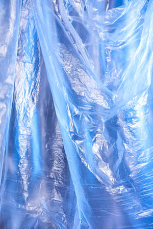 Abstract blue background of colorful textured holographic polyethylene