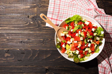 Organic vegetable salad of fresh lettuce, tomato, cucumber and cheeseの写真素材