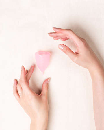 Menstrual cup in woman hands. Feminine hygieneの写真素材
