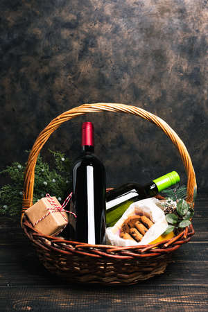 Bottles of red and white wine in Christmas basket.
