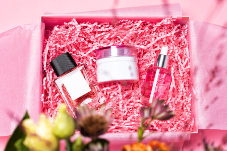 Beauty box with cosmetics filled with shredded pink paper