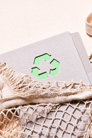 Mesh bags and reusable notepad with green recycling signの写真素材
