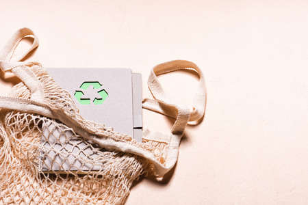 Mesh bags and reusable notepad with green recycling signの写真素材