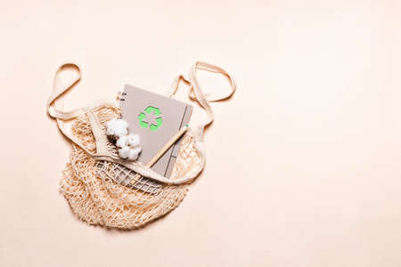 Mesh bags and reusable notepad with green recycling signの写真素材