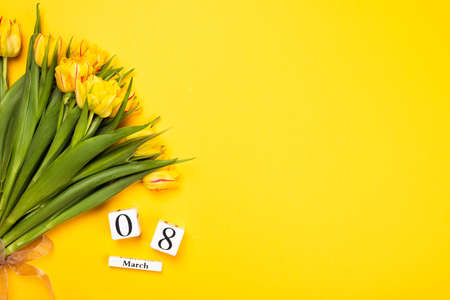 Bunch of tulips on illuminating yellow background