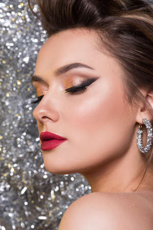 Beautiful brunette woman with perfect evening makeup
