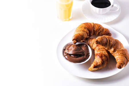 Croissant with chocolate hazelnut spread and cup of coffeeの写真素材