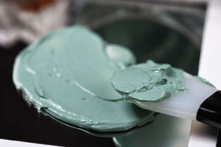 Natural spirulina face clay mask on marble and mirror backgroundの写真素材