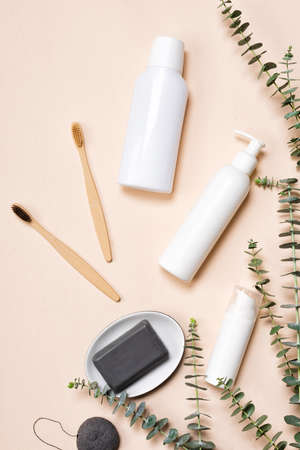 Bottles of mouthwash and bamboo toothbrushes with natural eucalyptus