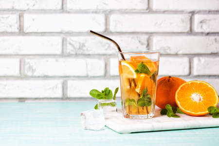 The glass of citrus iced tea on a marble tray and wooden table.の写真素材
