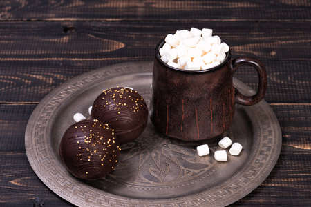 Chocolate ball bomb with marshmallows and milk