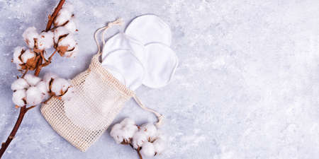 Reusable organic cotton makeup remover pads in bag on marble backgroundの写真素材