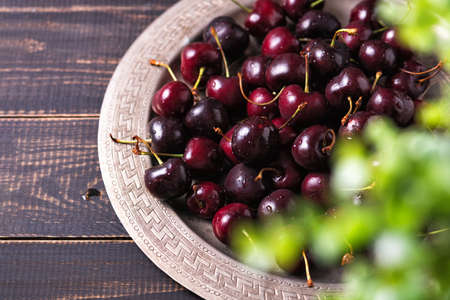 Pile of ripe sweet cherries with stalks in a tray