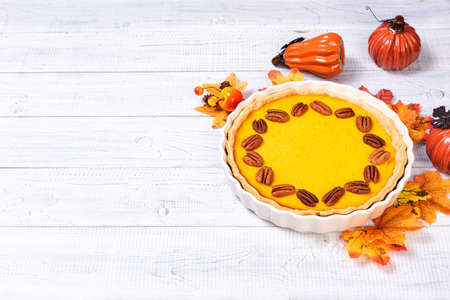 Homemade spicy pumpkin pie with cinnamon and pecan nutsの写真素材