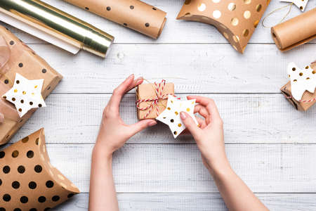 Female hands holding Christmas gift boxes and a starの写真素材