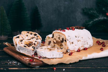 Christmas fruit cake with sugar powder on wooden board.の写真素材